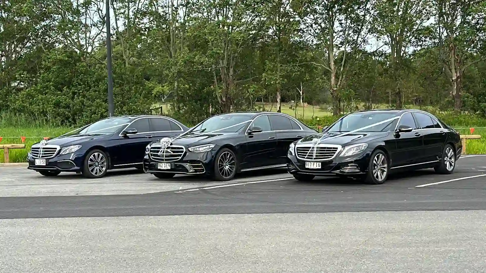 Three black luxury cars lined up for hire