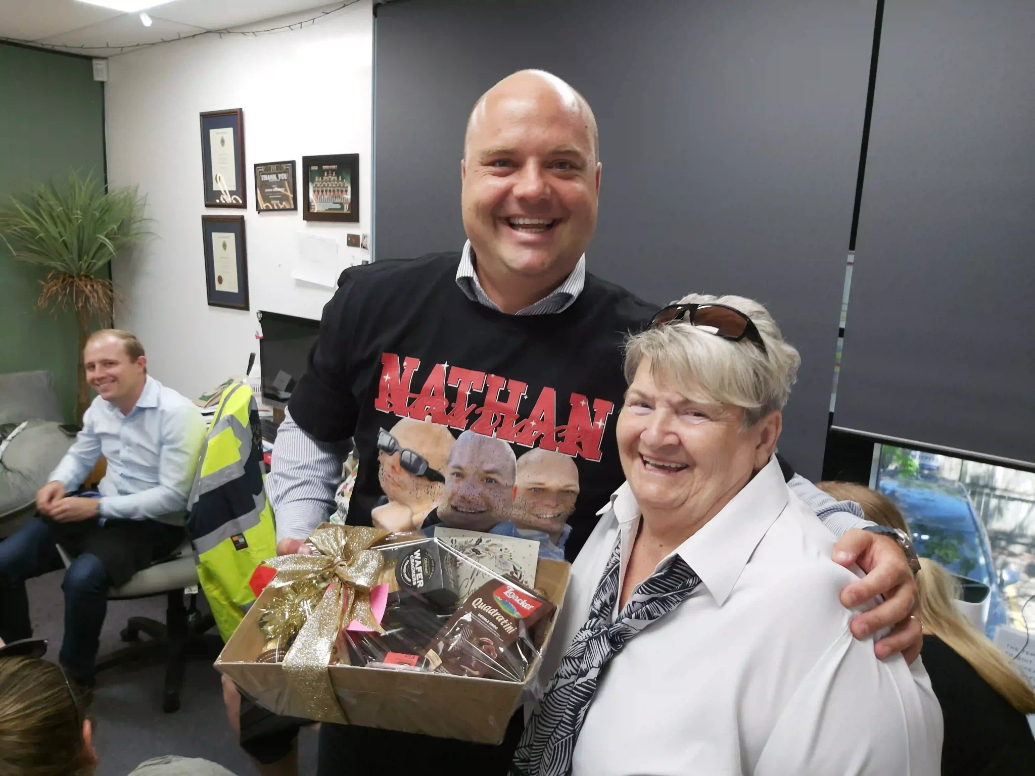Man giving gift to smiling woman near luxury ca