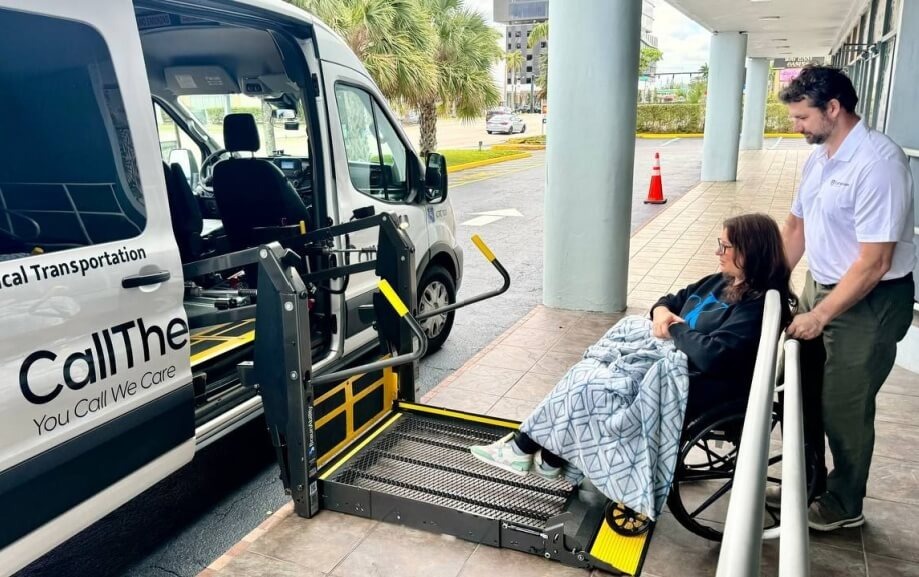 Chauffeur assisting patient safely into vehicle after hospital discharge