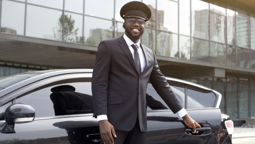 Chauffeur opening door for client during affordable transfer