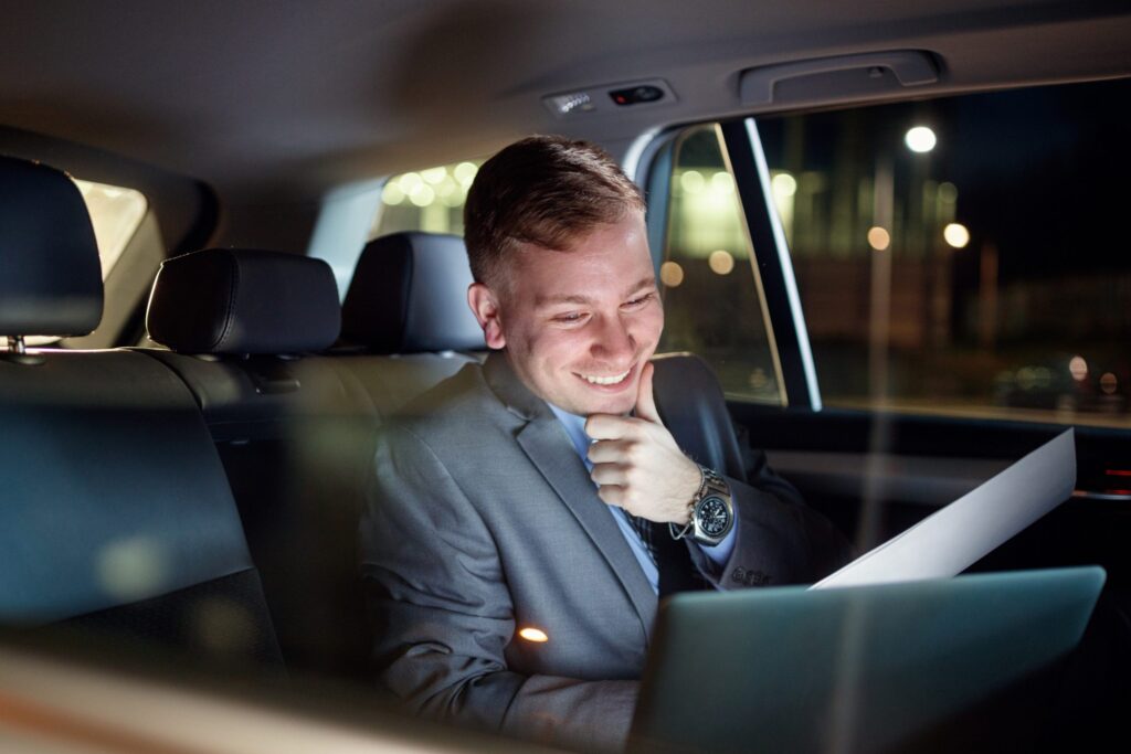 Passenger relaxed inside chauffeur-driven vehicle