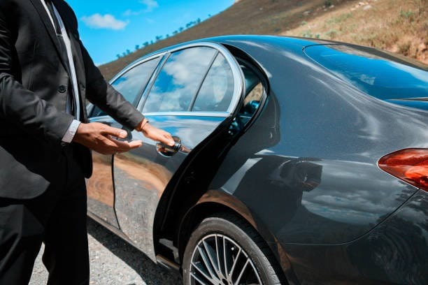 Chauffeur opening door for client during Adelaide chauffeur service